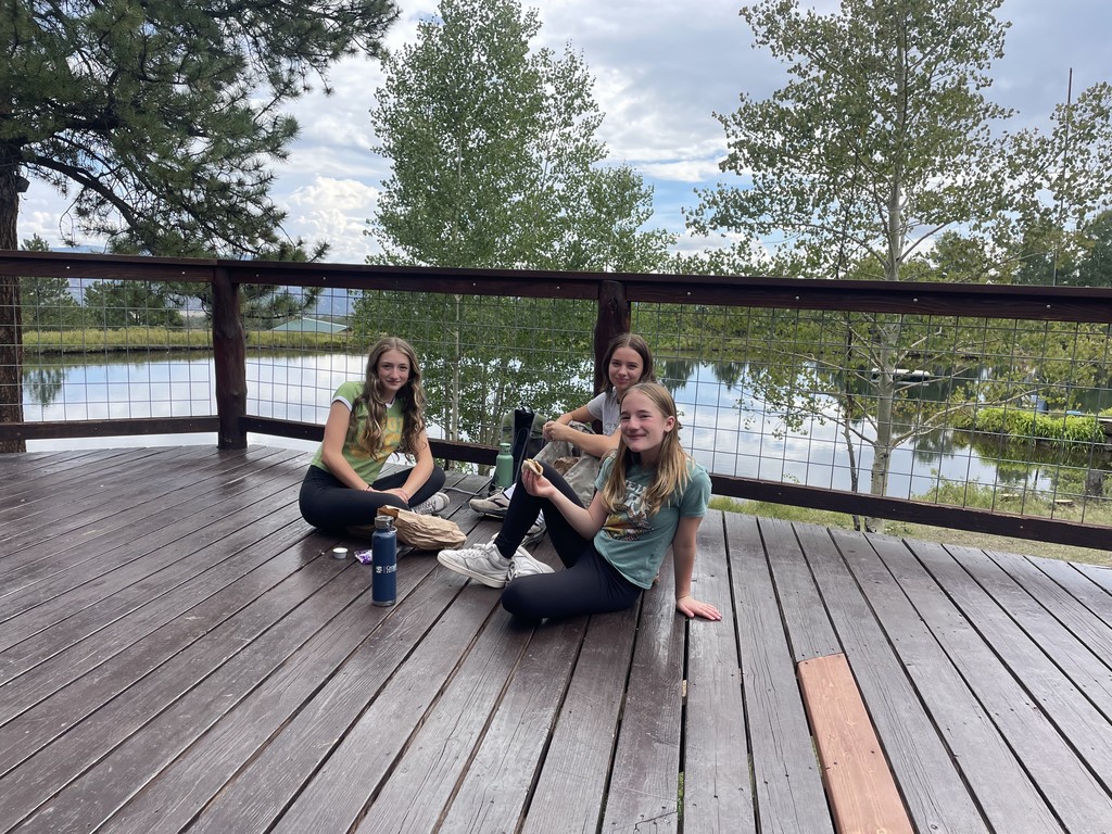 3 girls having snacks on deck