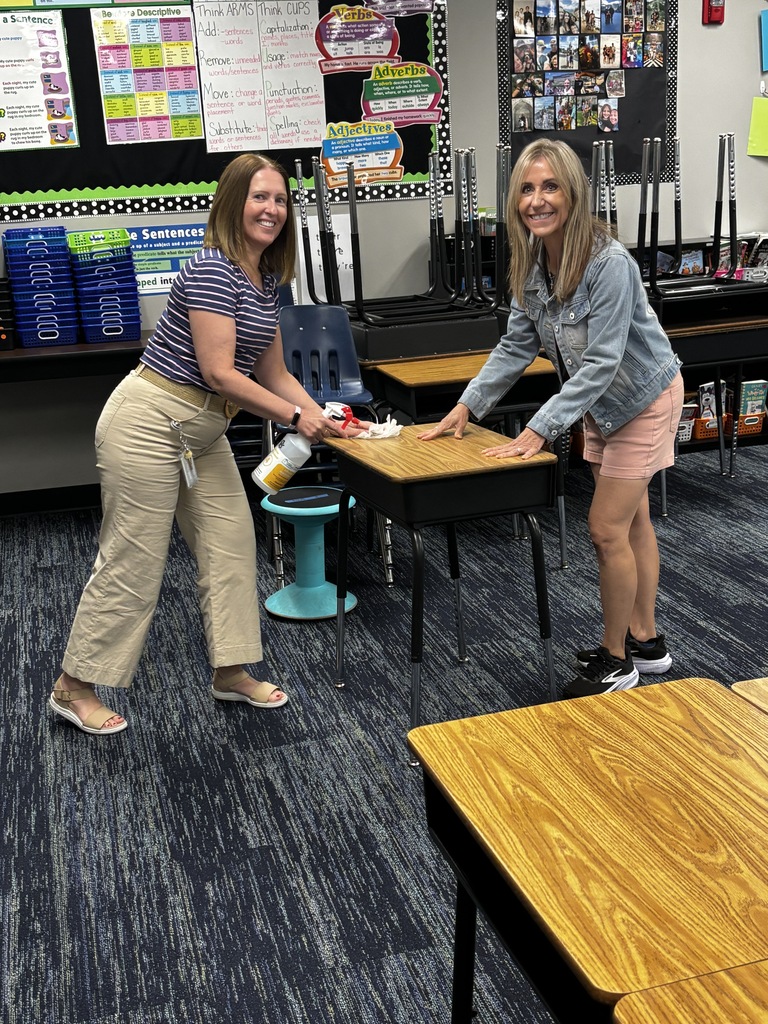 Mrs. Finley and Ms. Bell cleaning desks