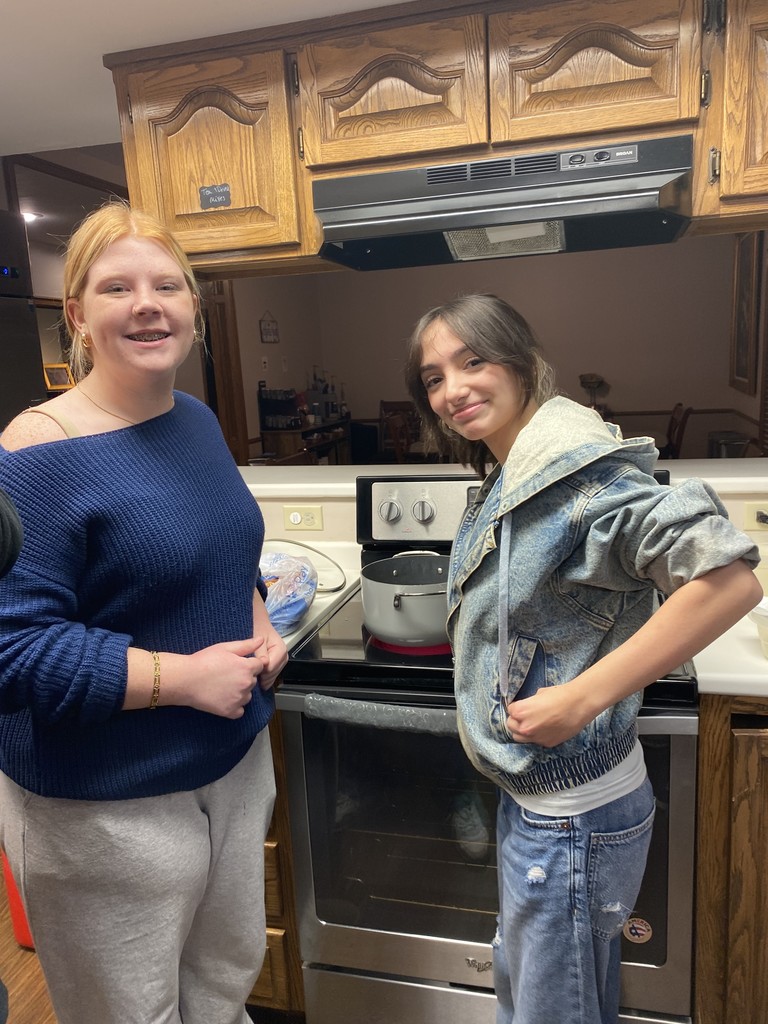 Students cooking french fries. 