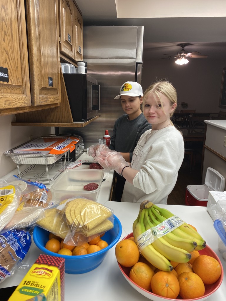 Students making burger patties. 