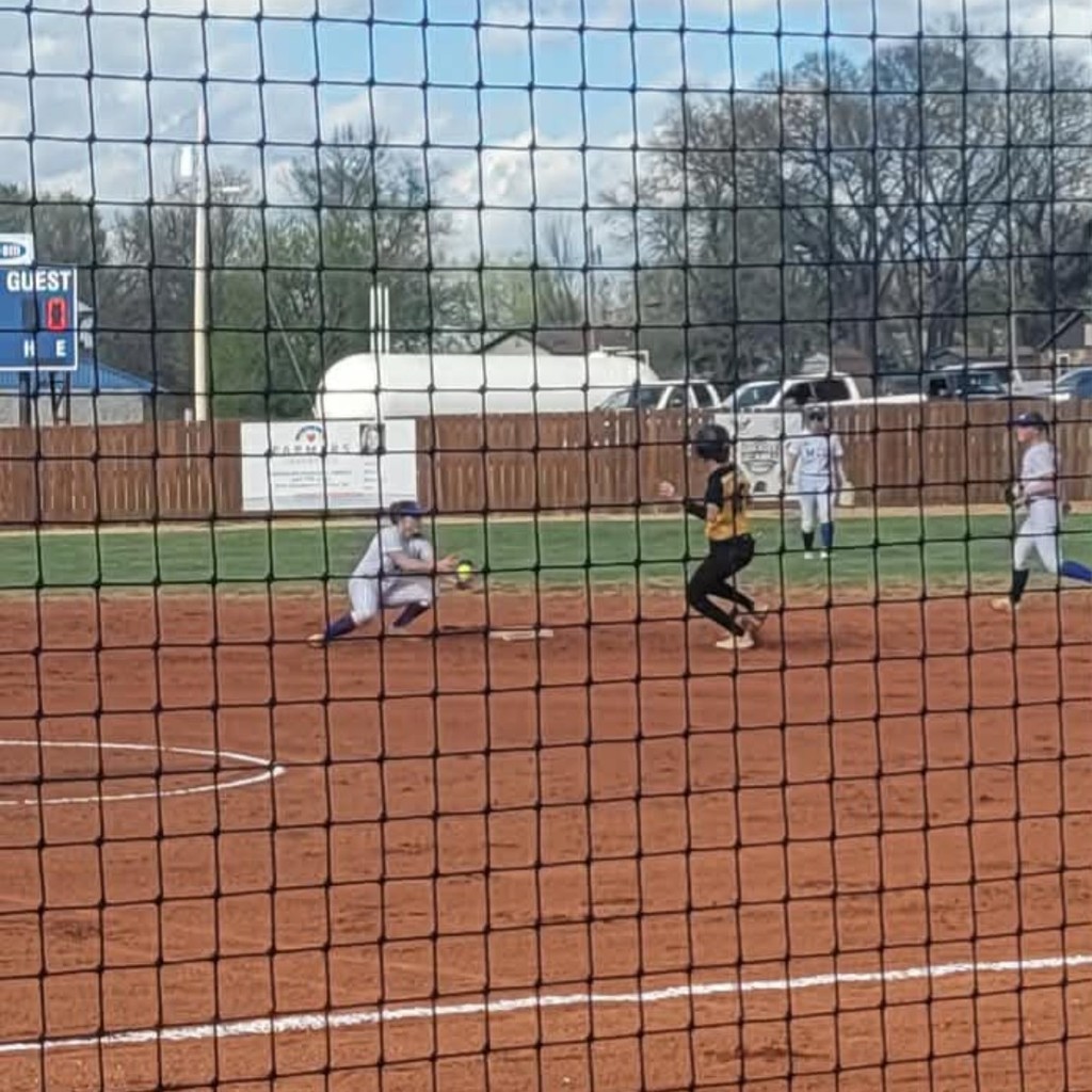 softball player stealing 2nd base