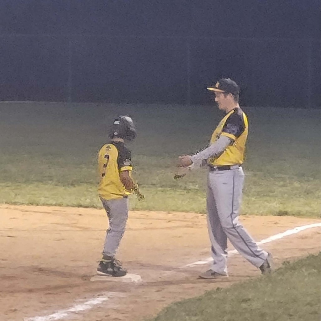 a coach and player at 1st base