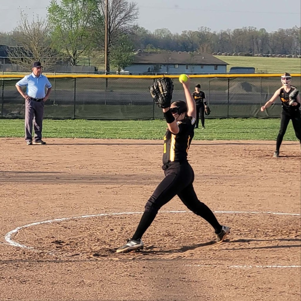 softball player pitching the ball