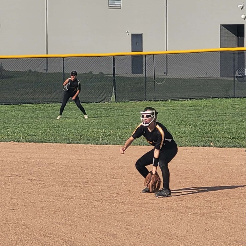 softball players ready to field the ball