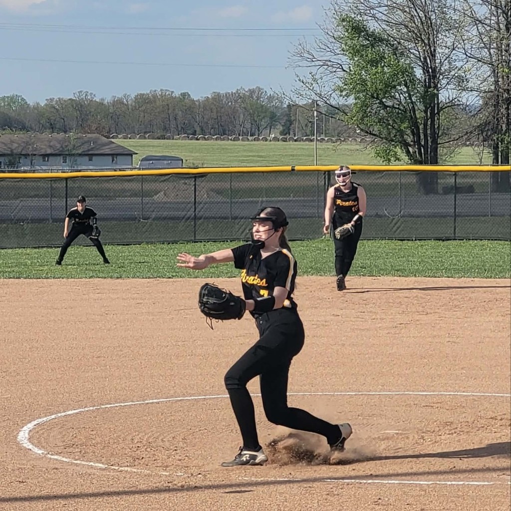 softball player pitching the ball
