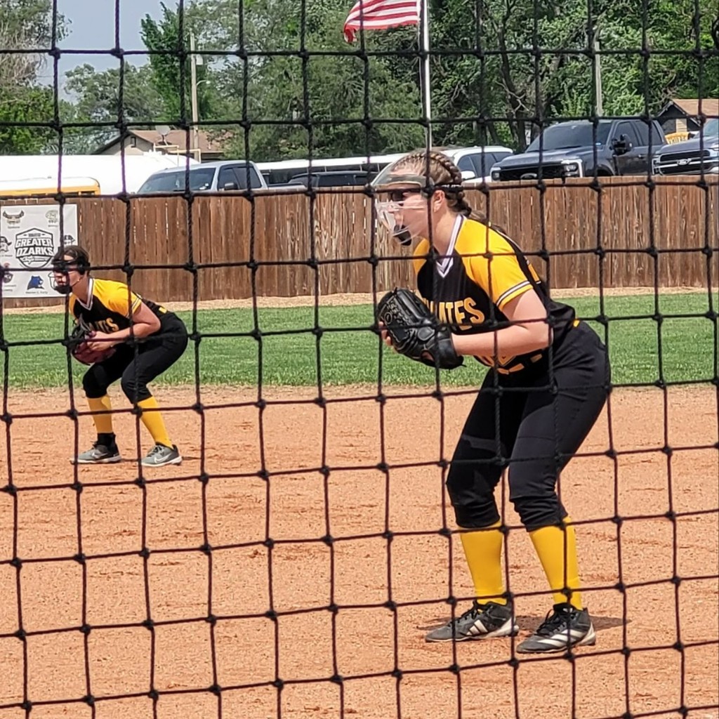 two pleasant hope softball players on the infield 