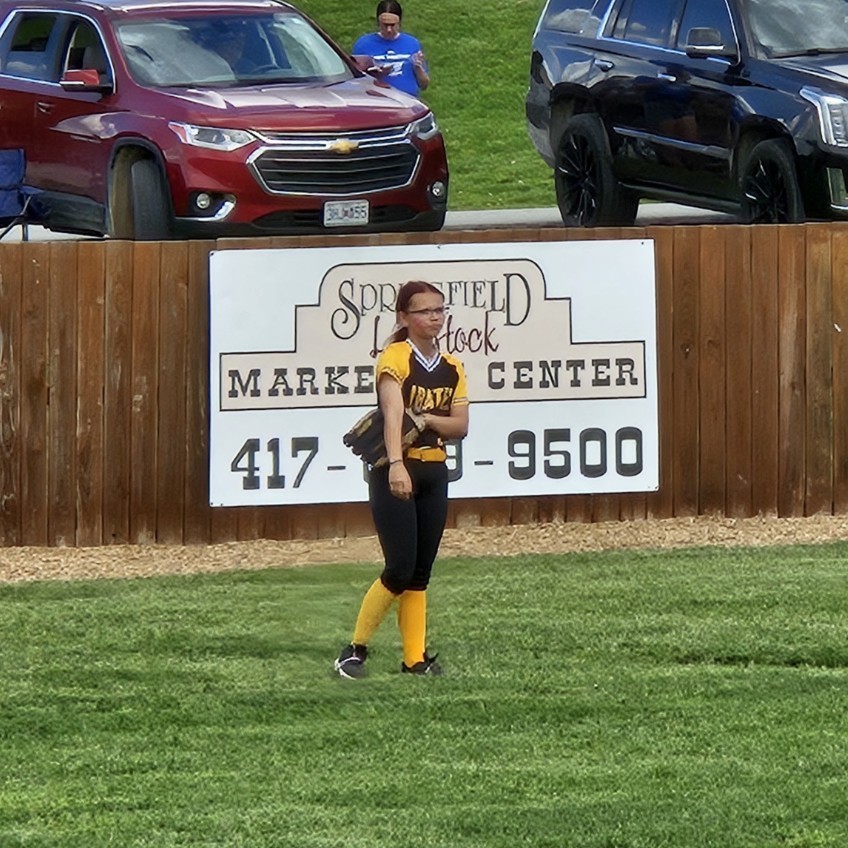 pleasant hope middle school softball player in the outfield 