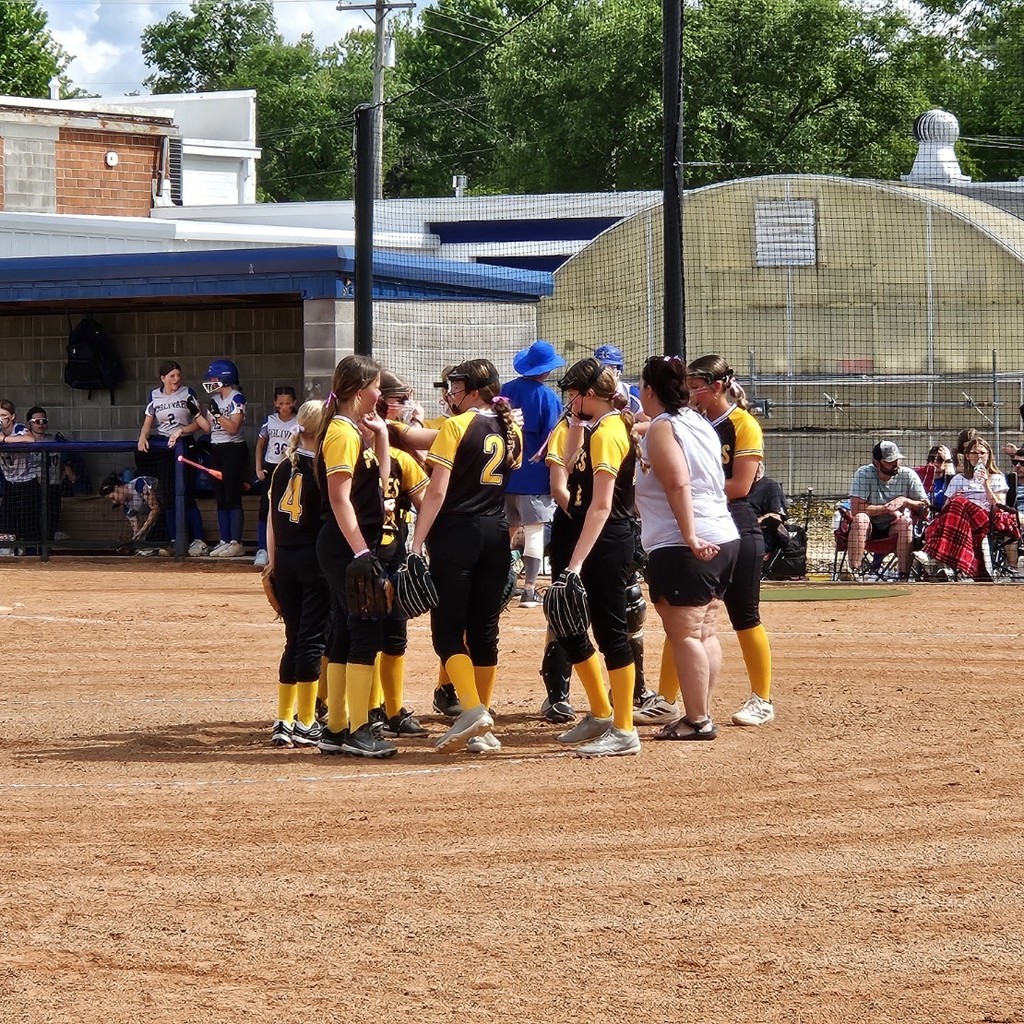 pleasant hope middle school softball coach talking to the players on the field