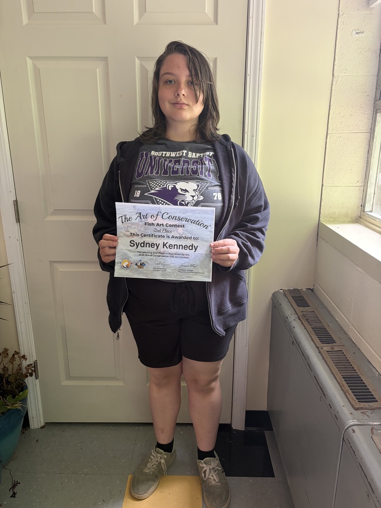 Student poses with certificate. 