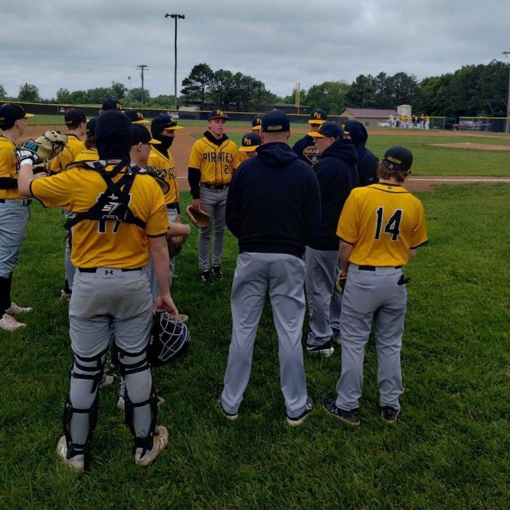 baseball coaches talking to the team 