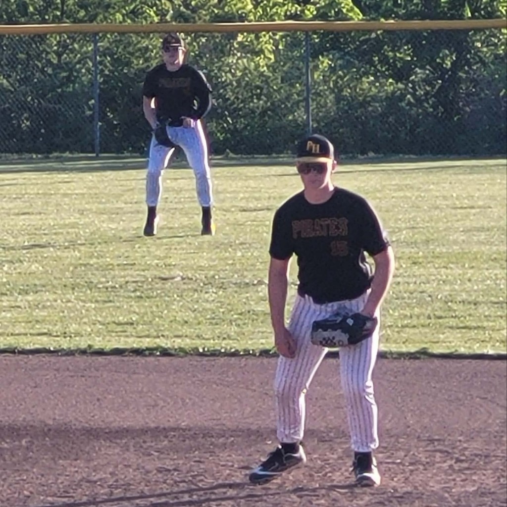 hs baseball player on the infield and a player in the outfield