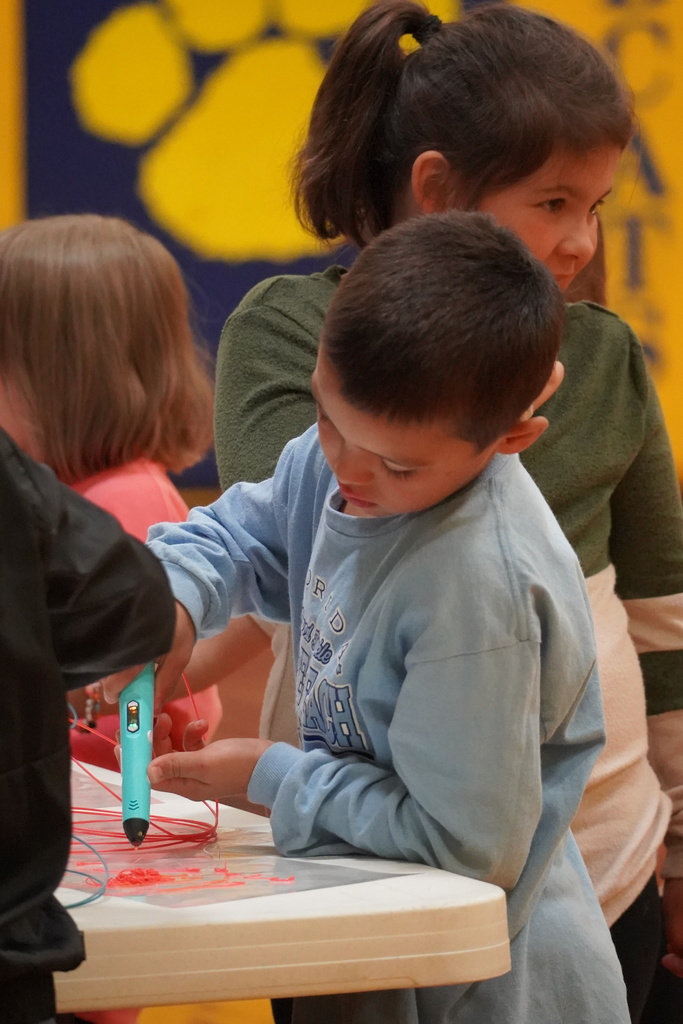 Students work with 3D pens