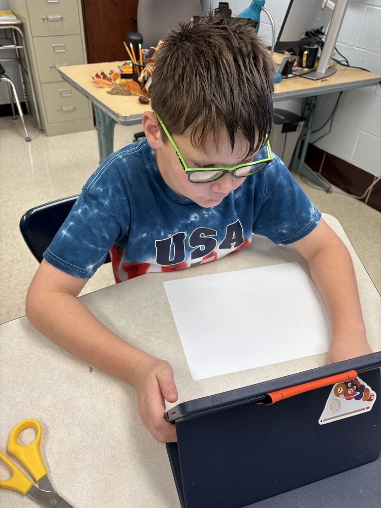 Students in Mrs. Kincaid’s class stand in a classroom holding homemade Mylar-style balloons shaped and decorated for Thanksgiving. 