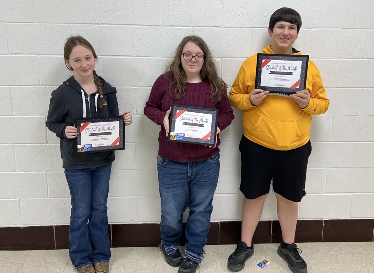students of the month holding awards and Dominos gift card