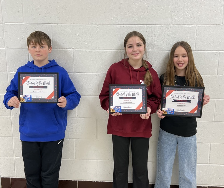 students of the month holding awards and Dominos gift card