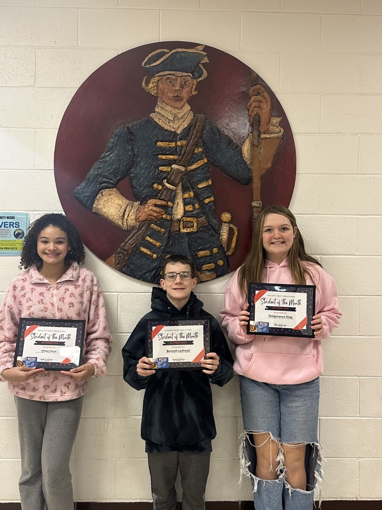 students of the month holding awards and Dominos gift card