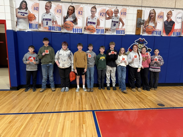 Celebrating success with a pizza party. Students pose.