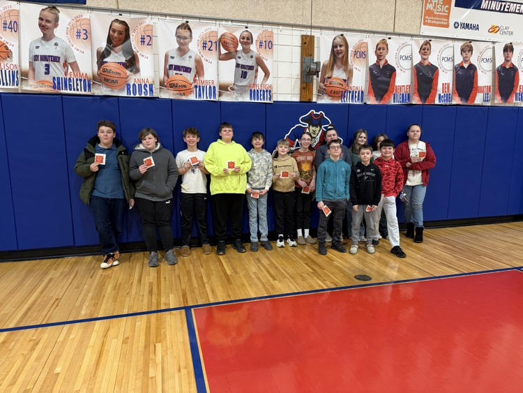 Celebrating success with a pizza party. Students pose.