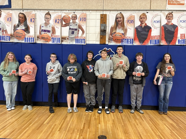 Celebrating success with a pizza party. Students pose.