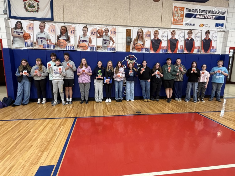 Celebrating success with a pizza party. Students pose.
