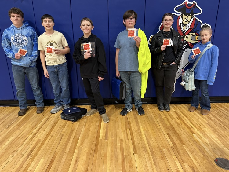 Celebrating success with a pizza party. Students pose.