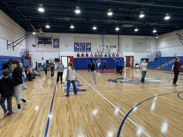 Students playing basketball at reward party.