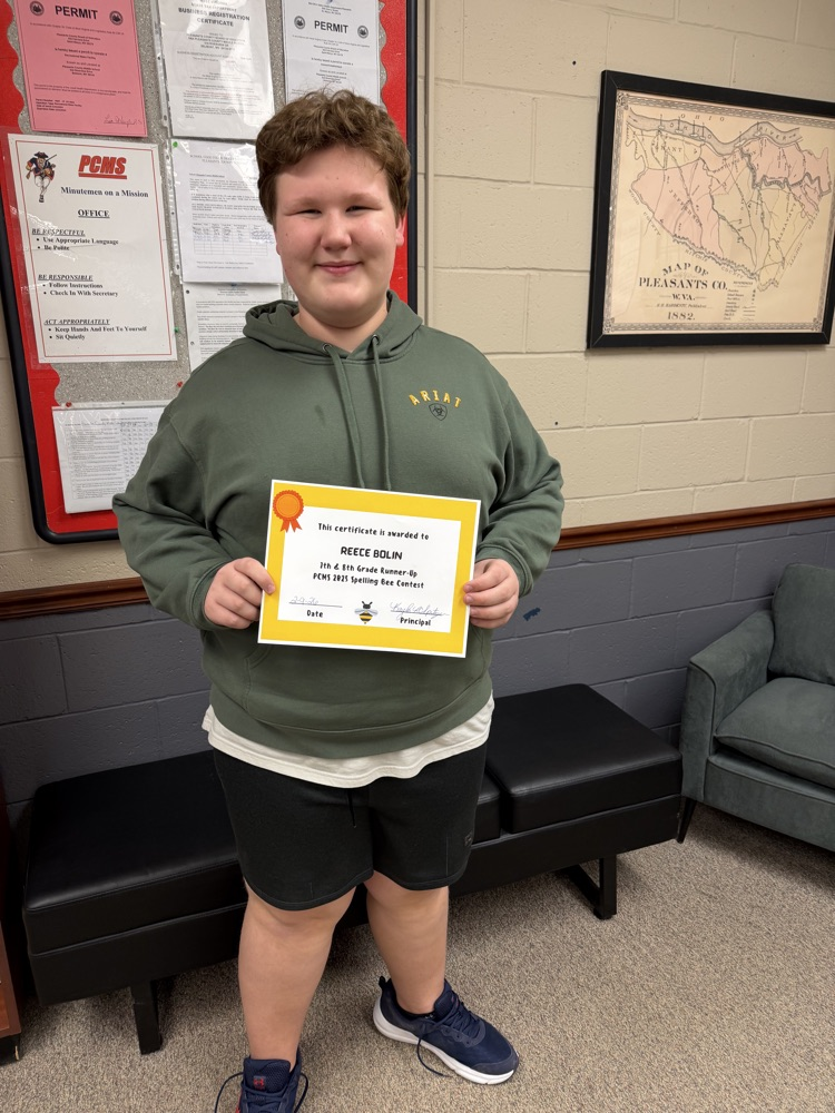 Spelling Bee winners for PCMS holding a certificate