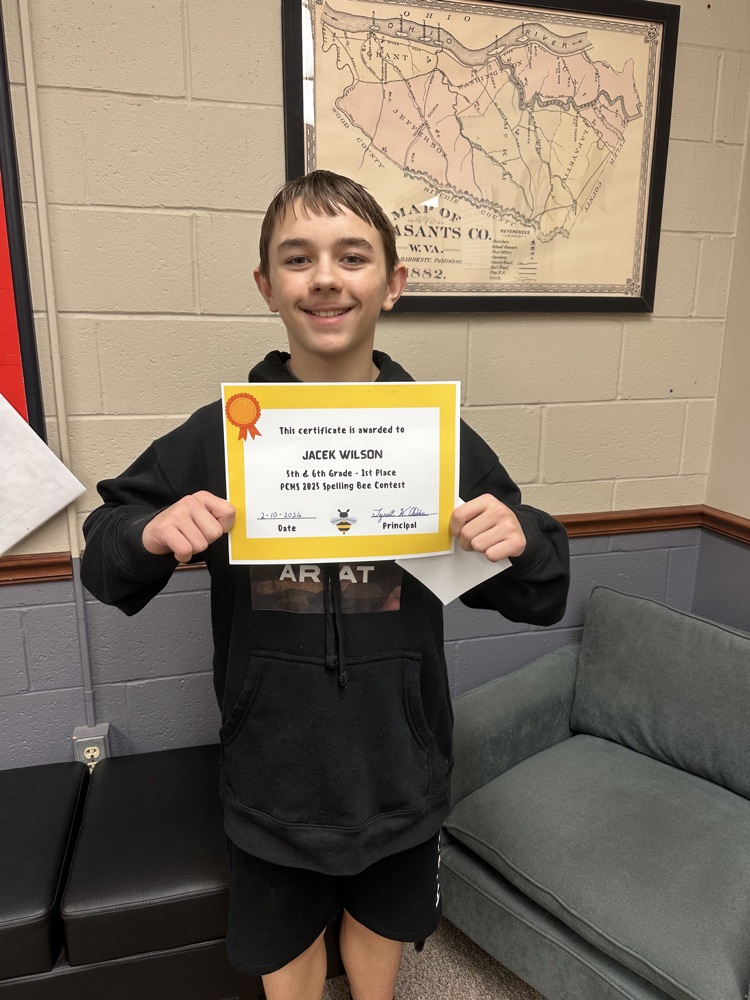 Spelling Bee winners for PCMS holding a certificate