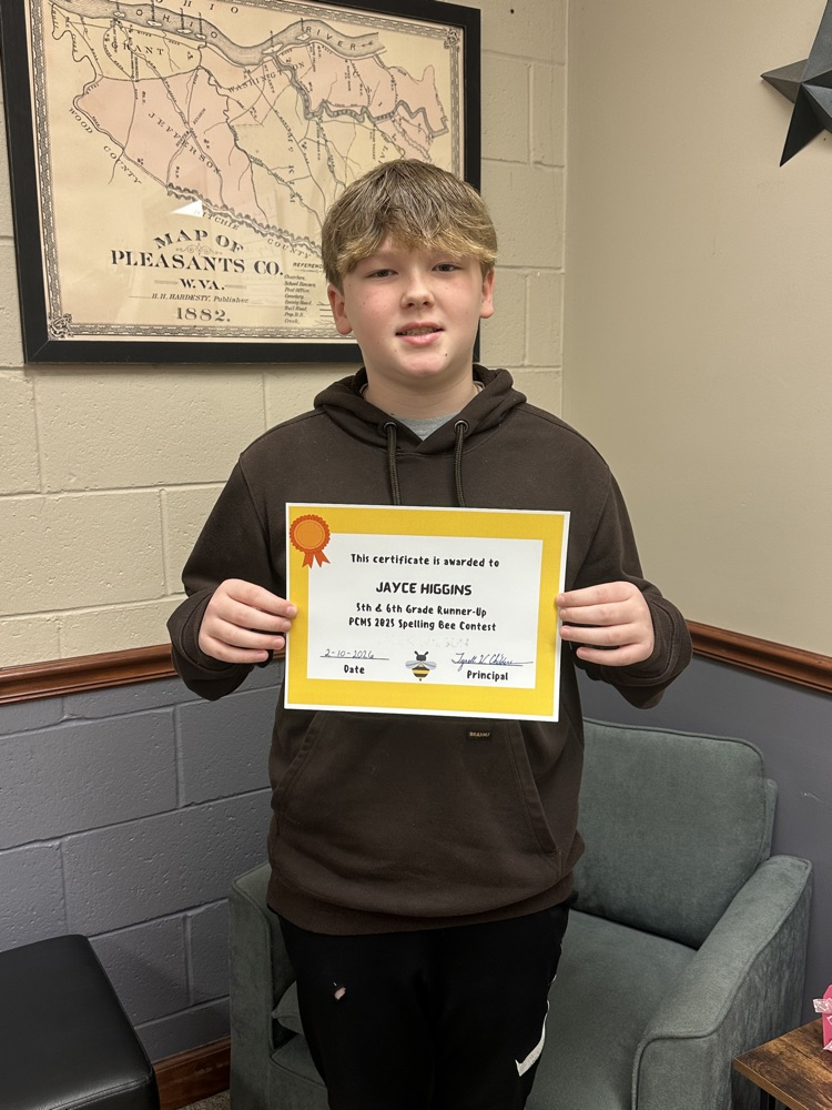 Spelling Bee winners for PCMS holding a certificate