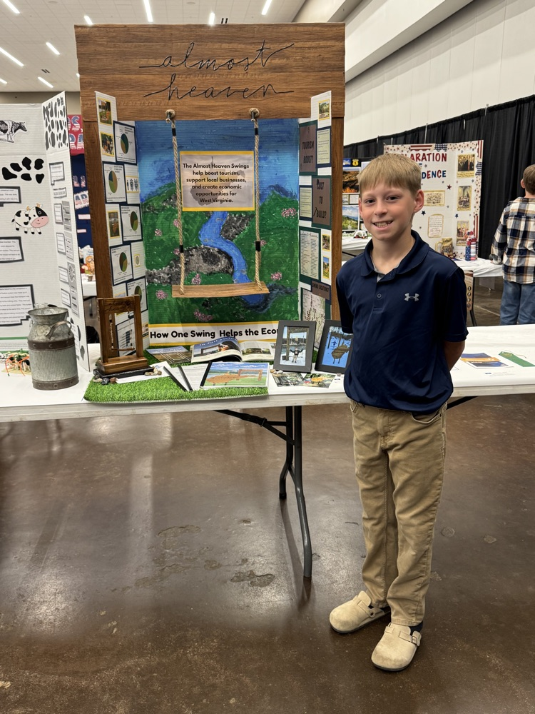 Student standing in front of social studies board for fair