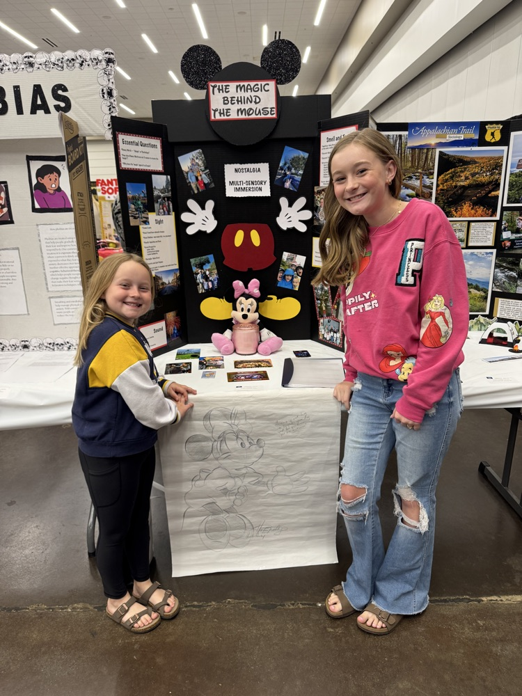 Student standing in front of social studies board for fair