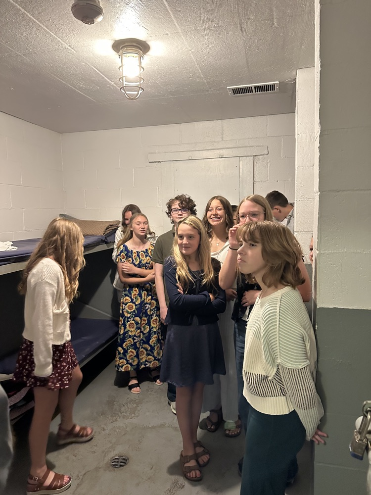 Seventh grade students standing inside the Pleasants County Courthouse, interacting with courthouse employees and observing daily operations during an educational field trip.