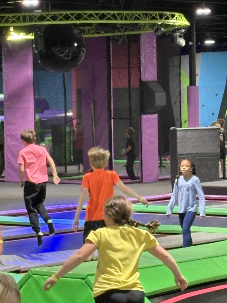 PCMS fifth grade students at The Hive trampoline park in Bridgeport, WV, jumping and playing indoors.
