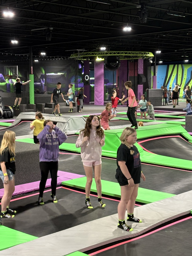 PCMS fifth grade students at The Hive trampoline park in Bridgeport, WV, jumping and playing indoors.