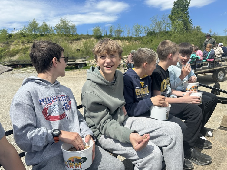 PCMS sixth grade students visiting a farm at Walnut Creek, interacting with animals.