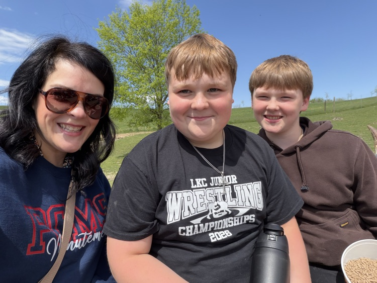 PCMS sixth grade students visiting a farm at Walnut Creek, interacting with animals.