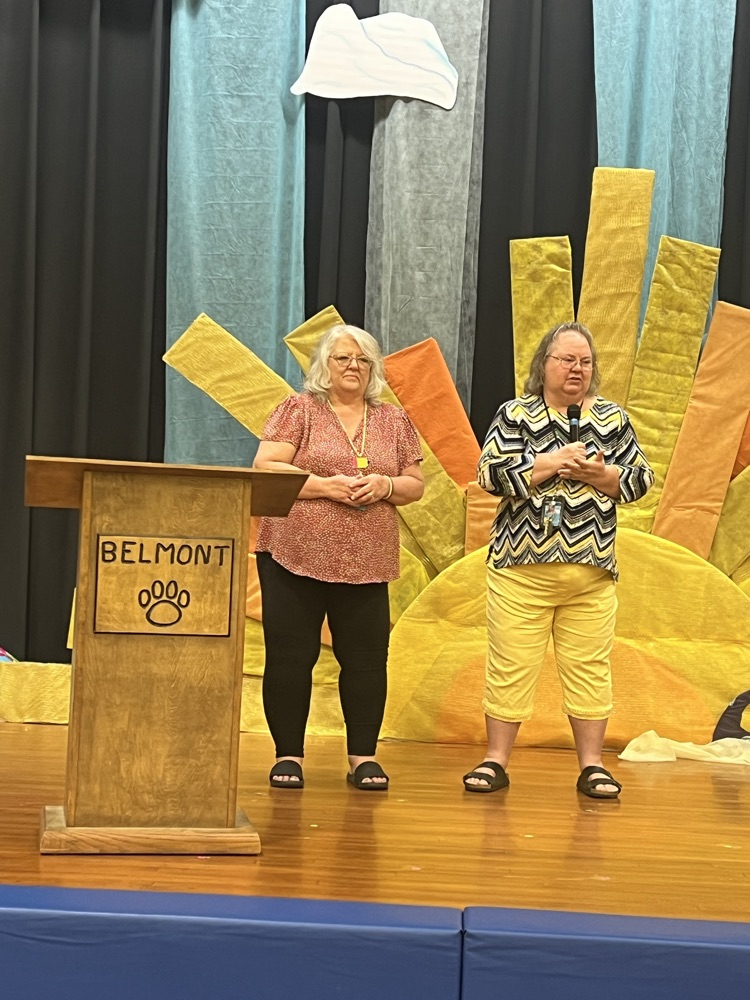 happy last day- two women standing on a stage