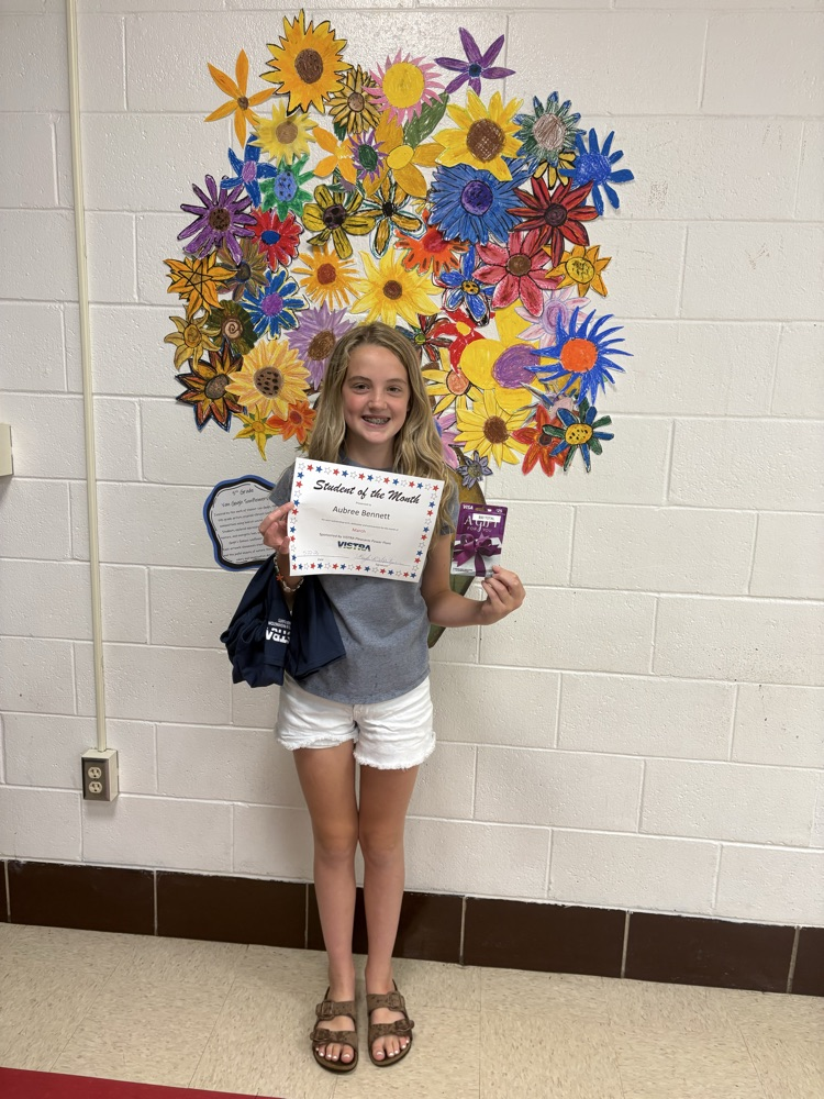 VISTRA Student of the month standing with award