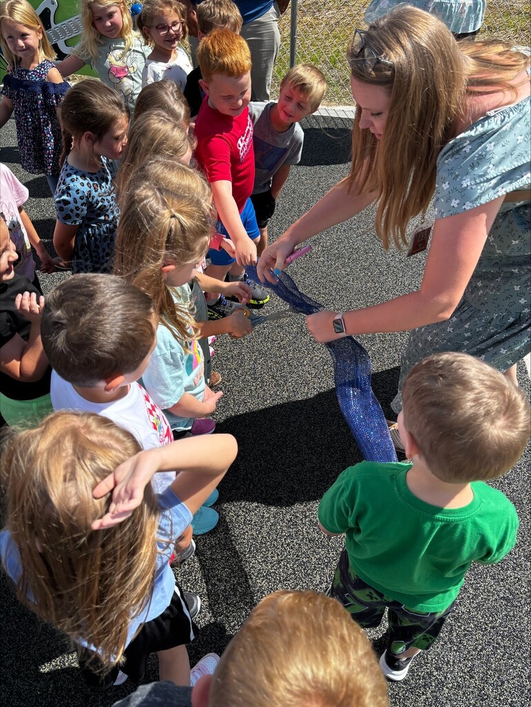 Photos from the ribbon-cutting celebration at Belmont Elementary School for the new Pre-K and Kindergarten–4th Grade playgrounds. Students are pictured exploring and enjoying the new playground equipment with excitement and smiles. The celebration highlights the new playgrounds and the community support that helped make the project possible.