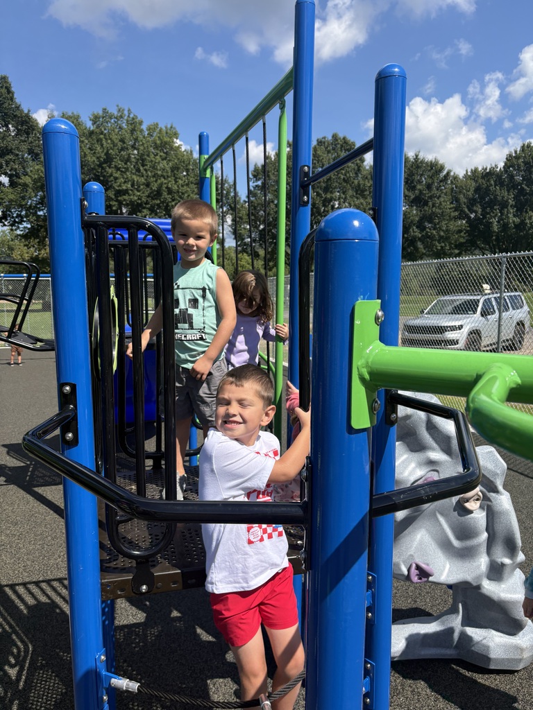 Photos from the ribbon-cutting celebration at Belmont Elementary School for the new Pre-K and Kindergarten–4th Grade playgrounds. Students are pictured exploring and enjoying the new playground equipment with excitement and smiles. The celebration highlights the new playgrounds and the community support that helped make the project possible.