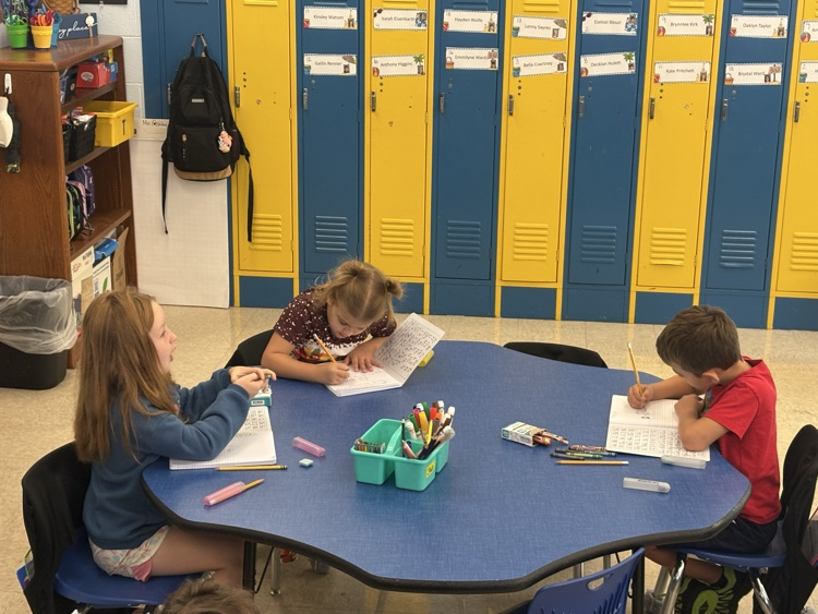 First grade students in Mrs. Ashley’s class work in their journals, practicing their writing skills.