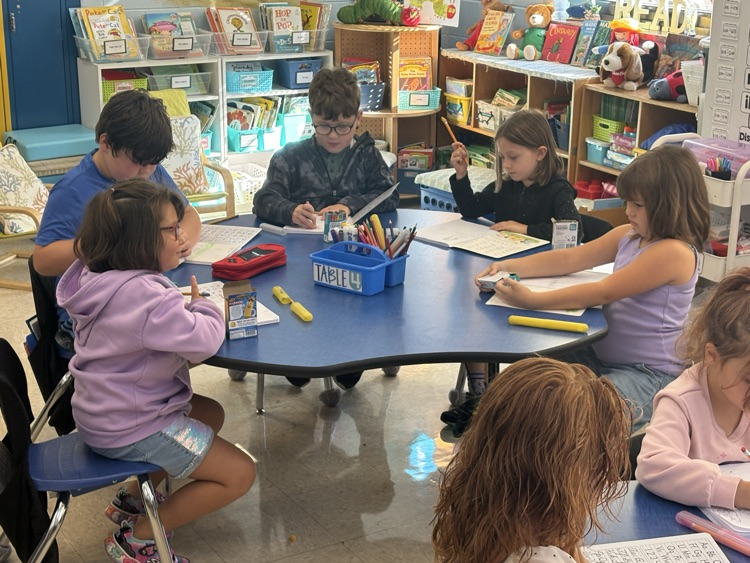 First grade students in Mrs. Ashley’s class work in their journals, practicing their writing skills.