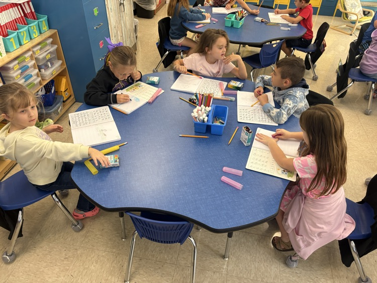 First grade students in Mrs. Ashley’s class work in their journals, practicing their writing skills.