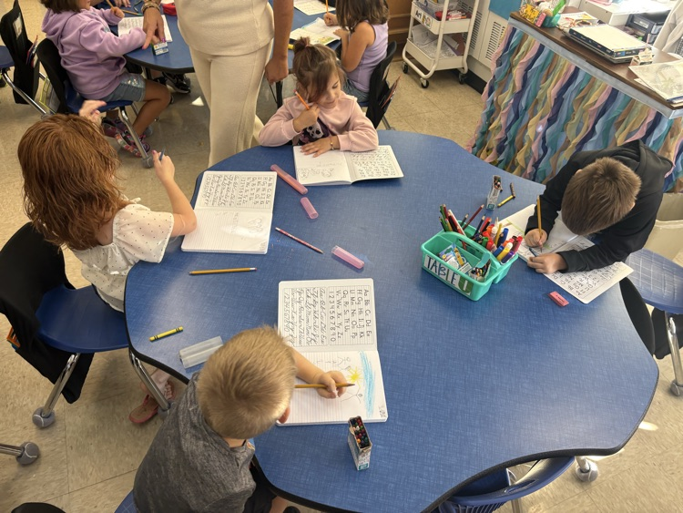 First grade students in Mrs. Ashley’s class work in their journals, practicing their writing skills.