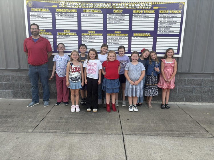 Fourth grade BES choir students performing the Star-Spangled Banner at a Pleasants County Middle School football game, directed by Mr. Negie.