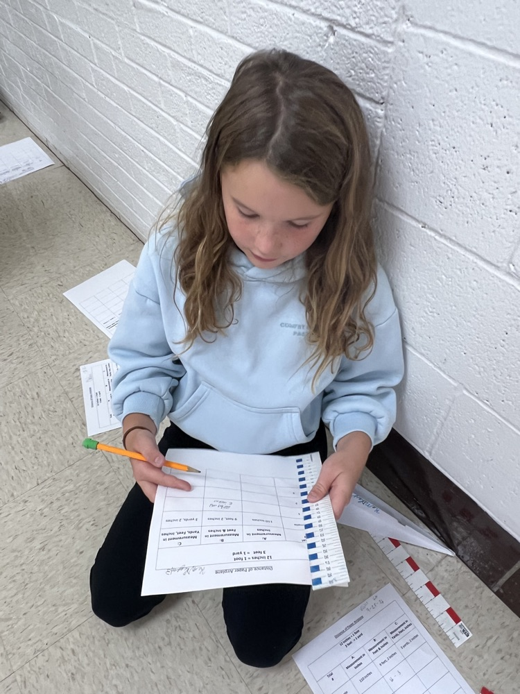 Fourth grade students designed airplanes while practicing measurement and converting feet to yards.