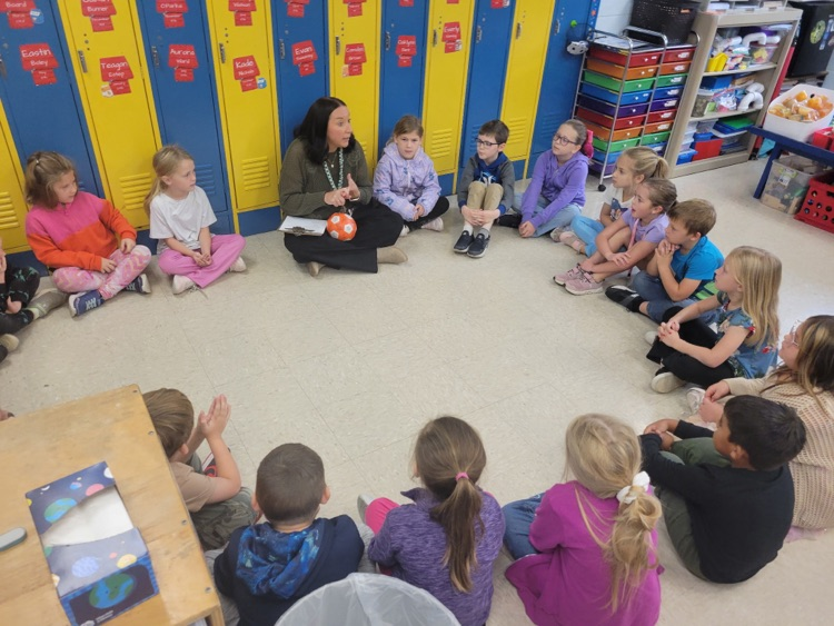 Mrs. Buchanan leads a counselor lesson on kindness as students pass a ball around and share kind words and compliments about one another.