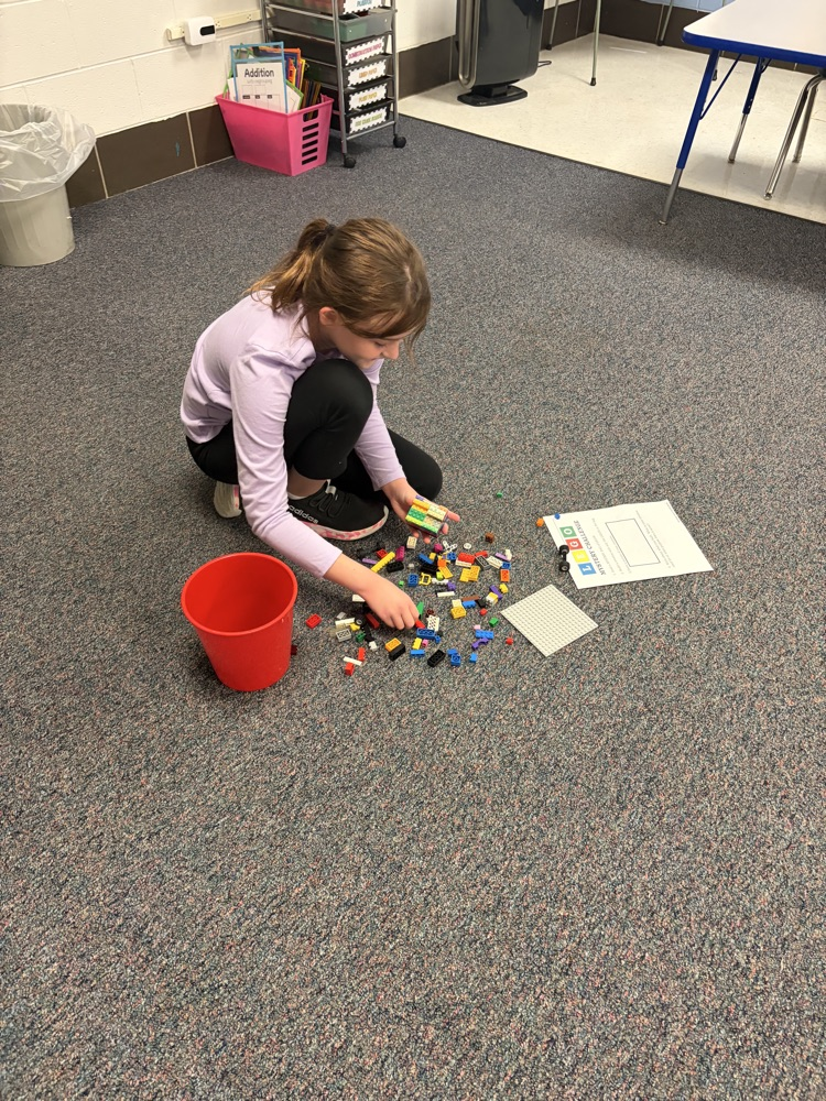 Fourth-grade students complete a mystery LEGO STEAM challenge, building unique creations and competing in a student-voted display.