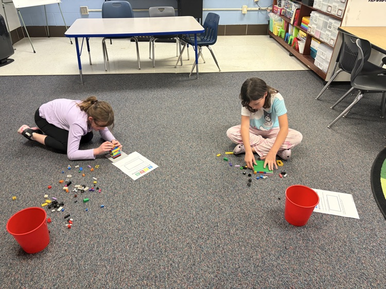 Fourth-grade students complete a mystery LEGO STEAM challenge, building unique creations and competing in a student-voted display.