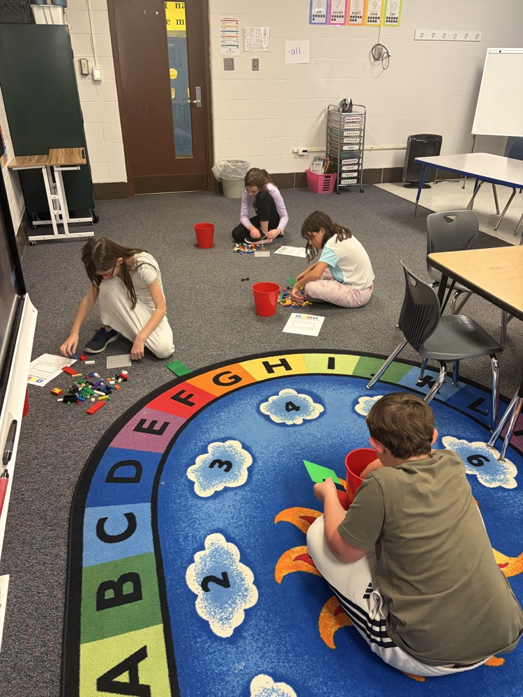 Fourth-grade students complete a mystery LEGO STEAM challenge, building unique creations and competing in a student-voted display.